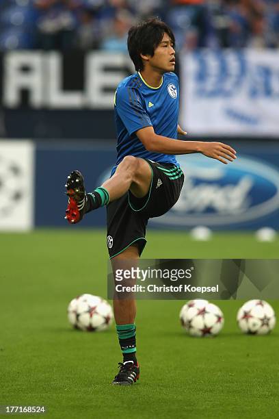 Atsuto Uchida of Schalke warm up prior to the UEFA Champions League Play-off first leg match between FC Schalke 04 and PAOK Saloniki at Veltins-Arena...