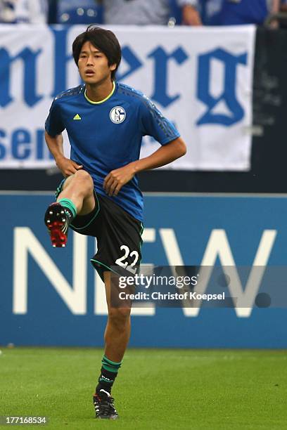 Atsuto Uchida of Schalke warm up prior to the UEFA Champions League Play-off first leg match between FC Schalke 04 and PAOK Saloniki at Veltins-Arena...