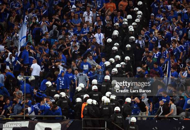 Riot police clash with fans of Schalke during the UEFA Champions League Play-off first leg match between FC Schalke 04 and PAOK Saloniki at...