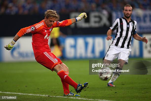 Timo Hildebrand of Schalke shoots the ball during the UEFA Champions League Play-off first leg match between FC Schalke 04 and PAOK Saloniki at...