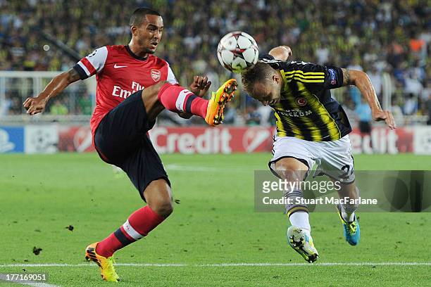 Theo Walcott of Arsenal challenged by Michal Kadlec of Fenerbache during the UEFA Champions League Play Off first leg match between Fenerbache SK and...