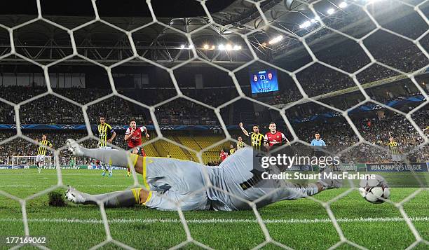 Aaron Ramsey's shot is fumbled by Fenerbahce goalkeeper Volkan Demirel for the 2nd Arsenal goal the UEFA Champions League Play Off first leg match...