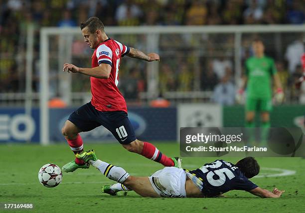 Jack Wilshere of Arsenal challenged by Emre Belozoglu of Fenerbache during the UEFA Champions League Play Off first leg match between Fenerbache SK...