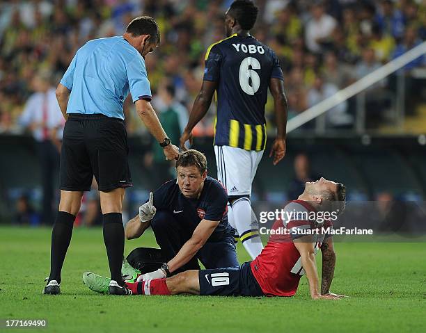 Arsenal physio Colin Lewin treats the injured Jack Wilshere during the UEFA Champions League Play Off first leg match between Fenerbache SK and...