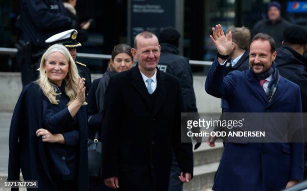 Crown Prince Haakon of Norway and Crown Princess Mette-Marit of Norway wave as they leave after attending festivities at the Berlin Wall Memorial, a...