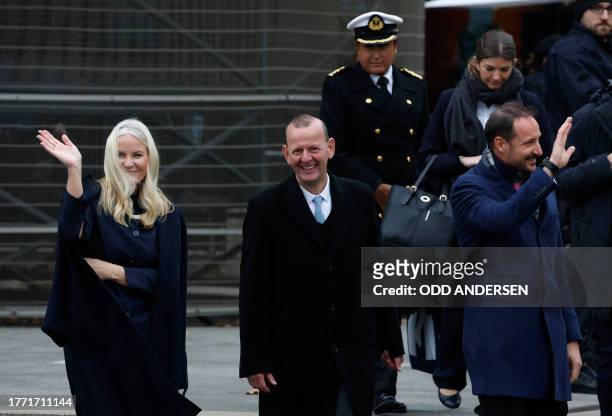 Crown Prince Haakon of Norway and Crown Princess Mette-Marit of Norway wave as they leave after attending festivities at the Berlin Wall Memorial, a...