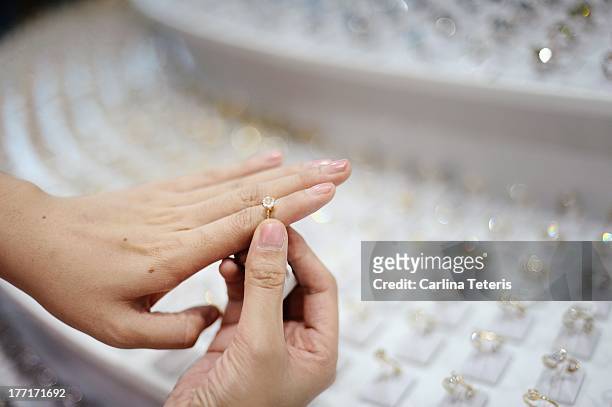 woman trying on rings - jeweller stock pictures, royalty-free photos & images