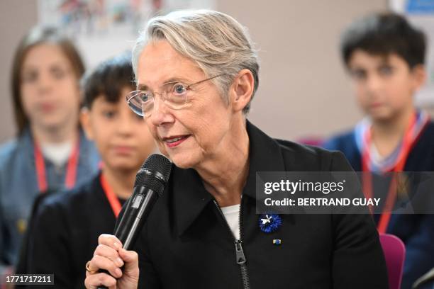 French Prime Minister Elisabeth Borne addresses pupils during her visit to a Paris' middle-school on the theme of school bullying on France's...