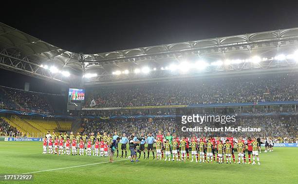 The Arsenal and Fenerbache teams line up before the UEFA Champions League Play Off first leg match between Fenerbache SK and Arsenal FC at sukru...