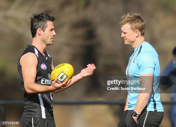 Alan Didak of the Magpies talks with Magpies coach Nathan Buckley during a Collingwood Magpies AFL training session at Olympic Park on August 22,...