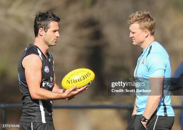 Alan Didak of the Magpies talks with Magpies coach Nathan Buckley during a Collingwood Magpies AFL training session at Olympic Park on August 22,...