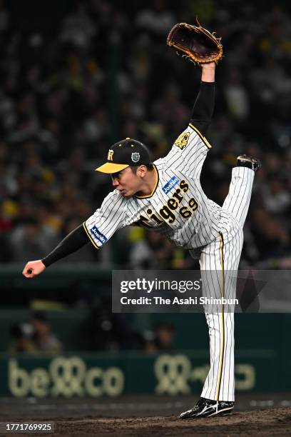 Daichi Ishii of the Hanshin Tigers throws in the 8th inning against Orix Buffaloes during the Japan Series Game Three at Hanshin Koshien Stadium on...