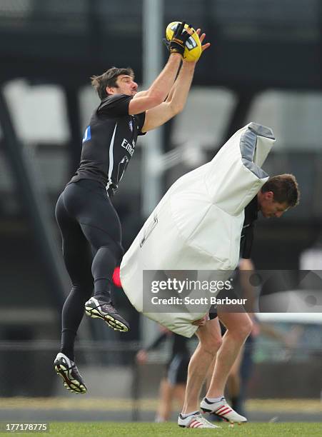 Quinten Lynch of the Magpies marks the ball during a Collingwood Magpies AFL training session at Olympic Park on August 22, 2013 in Melbourne,...