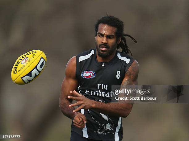 Harry O'Brien of the Magpies passes the ball during a Collingwood Magpies AFL training session at Olympic Park on August 22, 2013 in Melbourne,...