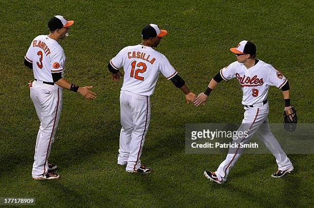Left fielder Nate McLouth of the Baltimore Orioles celebrates with teammates Alexi Casilla and Ryan Flaherty after defeating the Tampa Bay Rays at...