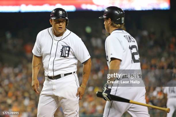 Miguel Cabrera of the Detroit Tigers celebrates with teammate Andy Dirks after scoring on the double to right field by Victor Martines during the...