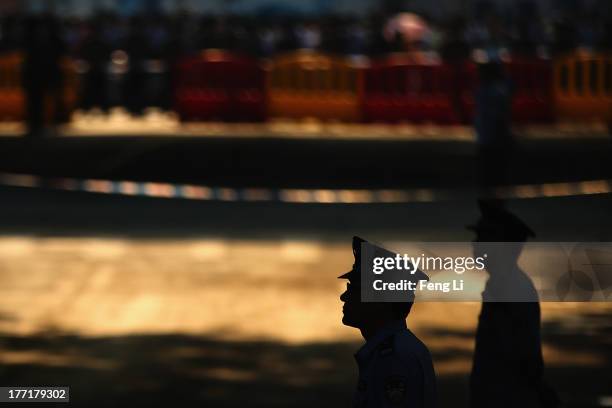 Chinese policemen guard outside the Jinan Intermediate People's Court on August 22, 2013 in Jinan, China. Former Chinese politician Bo Xilai is...