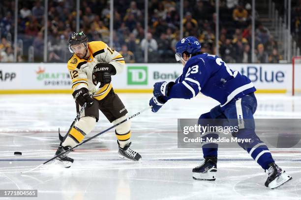 Kevin Shattenkirk of the Boston Bruins passes the puck past Matthew Knies of the Toronto Maple Leafs during the third period at TD Garden on November...