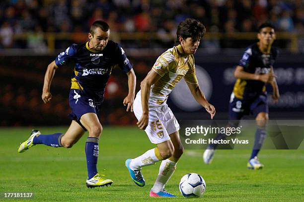 Carlos Orrantia of Pumas fights for the ball with Oscar Talancon of San Luis during a match between San Luis and Pumas as part of the Apertura 2013...
