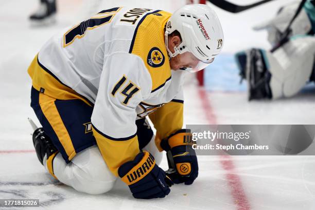 Gustav Nyquist of the Nashville Predators picks up his knocked out tooth during the first period against the Seattle Kraken at Climate Pledge Arena...
