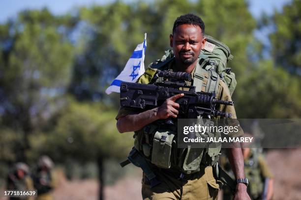 An Israeli solider arrives for a drill in the annexed Golan Heights on November 9 amid increasing cross-border tensions between Hezbollah and Israel...