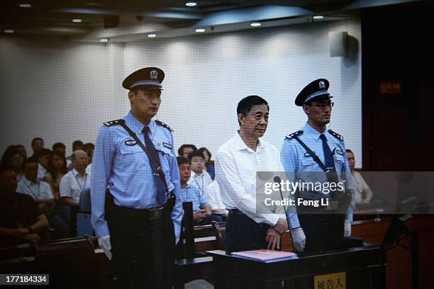 Screen shows the picture of the trial of disgraced Chinese politician Bo Xilai before a press conference in Jihua Hotel on August 22, 2013 in Jinan,...