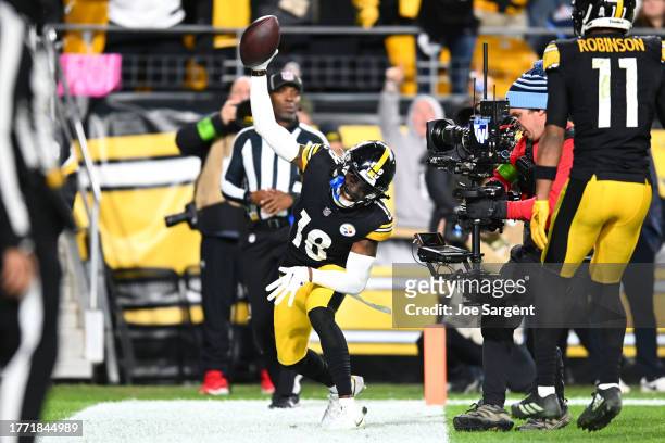 Diontae Johnson of the Pittsburgh Steelers celebrates a touchdown in the fourth quarter against the Tennessee Titans at Acrisure Stadium on November...