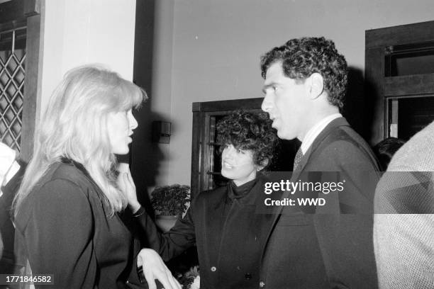 Alana Collins, Jennifer Bogart, and Elliott Gould attend a party in Beverly Hills, California, on February 17, 1982.