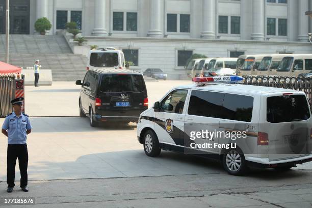 The police car transporting former Chinese politician Bo Xilai arrives at the Jinan Intermediate People's Court on August 22, 2013 in Jinan, China....
