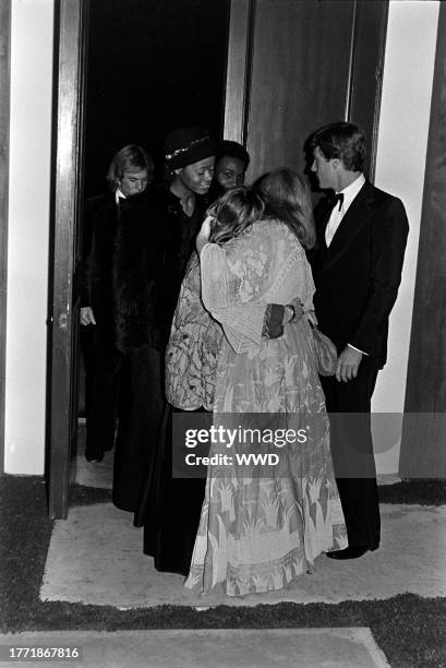 Sue Mengers and Ryan O'Neal welcome guests to a party at the Mengers residence in Los Angeles, California, celebrating the premiere of "Barry Lyndon"...