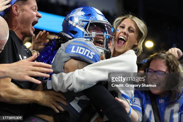 Jahmyr Gibbs of the Detroit Lions celebrates with fans in the front row after a touchdown against the Las Vegas Raiders at Ford Field on October 30,...