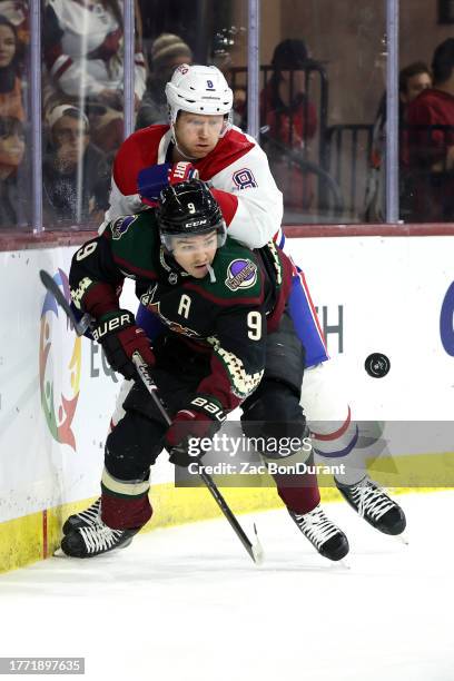 Clayton Keller of the Arizona Coyotes skates for a loose puck against Mike Matheson of the Montreal Canadiens during the second period at Mullett...