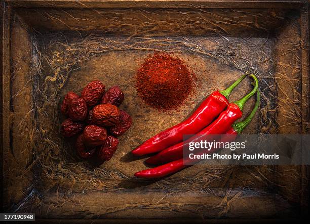 still life with red chillis, powder and red dates - chilli powder imagens e fotografias de stock