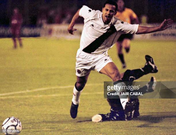 Junino of Brazil runs past Luis Barbat of Columbia during the game in Cali, Columbia on 14 March 2001. The Brazilian team Vasco de Game won 3-0....
