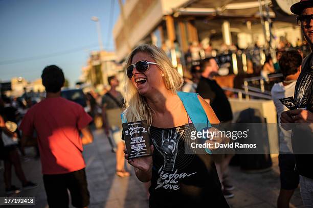 Girl gives flyers out in front of Cafe del Mar in Sant Antonio on August 21, 2013 near Ibiza, Spain. The small island of Ibiza lies within the...