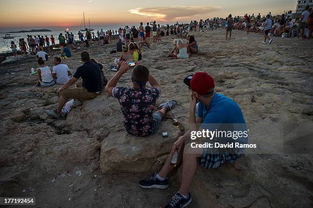 Tourists gather to watch the sunset in front of Cafe del Mar in Sant Antonio on August 21, 2013 near Ibiza, Spain. The small island of Ibiza lies...