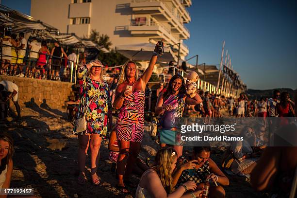 Tourists gather to watch the sunset in front of Cafe del Mar in Sant Antonio on August 21, 2013 near Ibiza, Spain. The small island of Ibiza lies...
