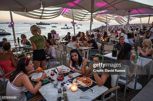 Tourists have dinner at Mint Lounge Bar in Sant Antonio on August 21, 2013 near Ibiza, Spain. The small island of Ibiza lies within the Balearics...