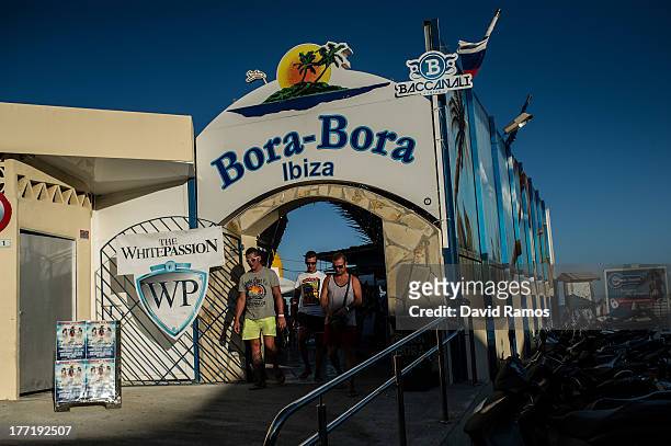 Tourists leave the Bora-Bora Bar at the Platja d'en Bossa on August 21, 2013 in Ibiza, Spain. The small island of Ibiza lies within the Balearics...