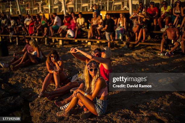 Tourists gather to watch the sunset in front of Cafe del Mar in Sant Antonio on August 21, 2013 near Ibiza, Spain. The small island of Ibiza lies...