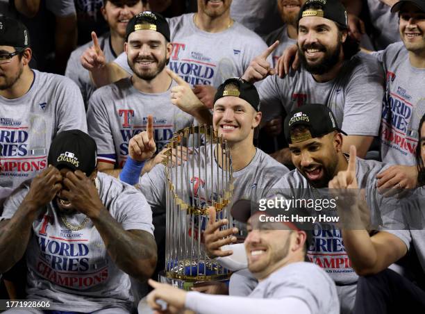 Josh Jung of the Texas Rangers smiles with the trophy after defeating the Arizona Diamondbacks 5-0 in Game Five of the World Series at Chase Field on...