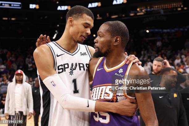 Kevin Durant of the Phoenix Suns talks with Victor Wembanyama of the San Antonio Spurs following the NBA game at Footprint Center on November 02,...