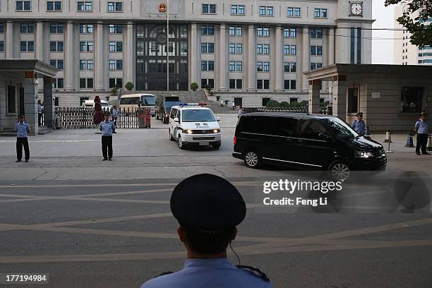 The police car transporting former Chinese politician Bo Xilai leaves the Jinan Intermediate People's Court after first day trial on August 22, 2013...