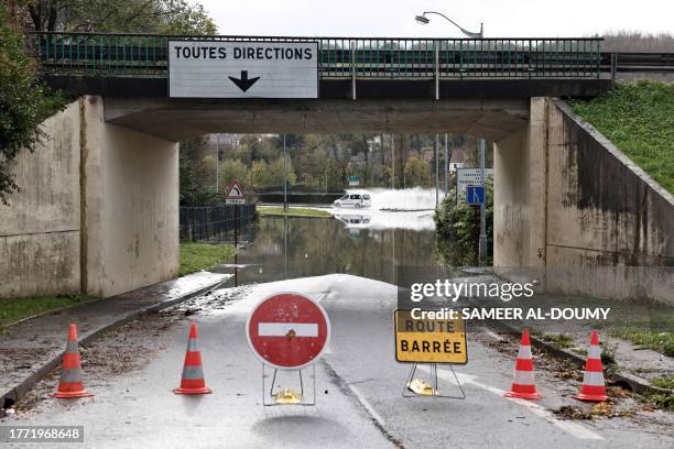 Car runs by a flooded street in Saint-Etienne-au-Mont, northern France, on November 9, 2023. The Pas-de-Calais region was once again hit by...