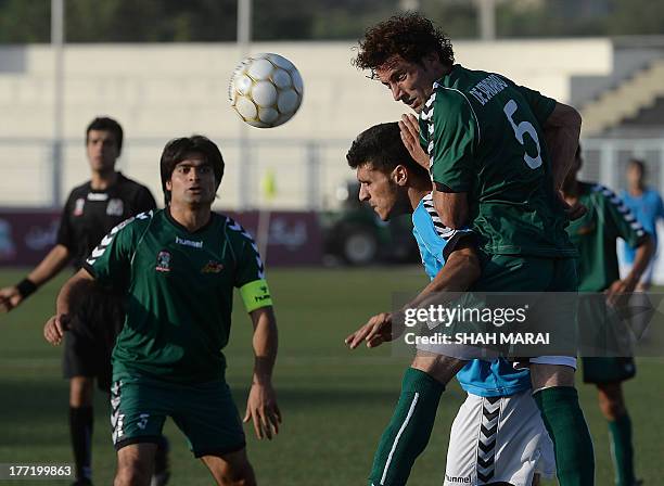 Afghan football players from Tofaan Harirod and Spinghar Bazan fight for the ball during game of the Roshan Afghan premiere league at the Afghanistan...