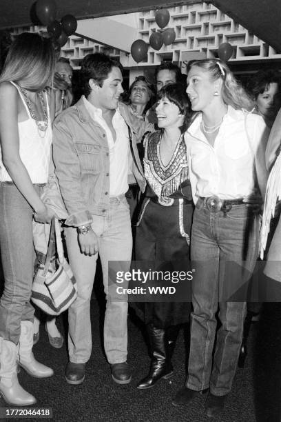 Guest, Chad McQueen, Neile Adams, and Terry McQueen attend an event at the Santa Monica Civic Auditorium in Santa Monica, California, on May 11, 1982.