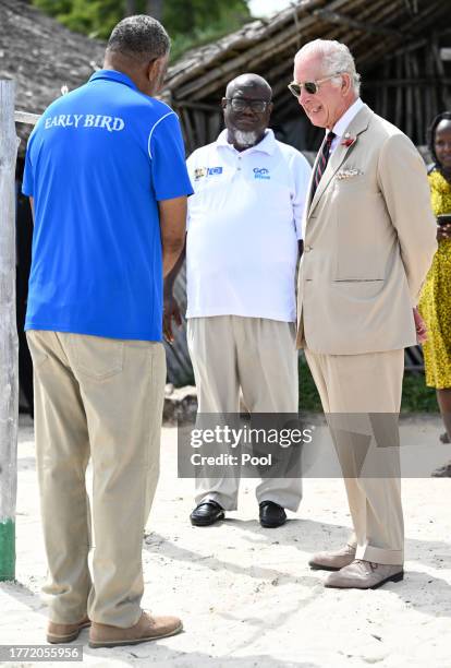 King Charles III meets members of Flipflopi, a movement which aims to end single use plastic, transforming and upcycling litter to preserve the...