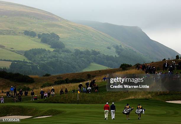 Players are pictured against the mountain backdrop during the first round of the Johnnie Walker Championship at Gleneagles on August 22, 2013 in...