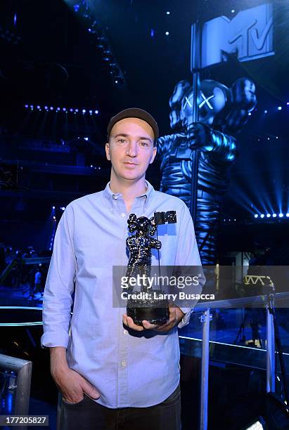 Artist KAWS, designer of the 2013 Moonman attends a press conference for the 2013 MTV Video Music Awards at the Barclays Center on August 22, 2013 in...