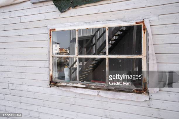 old whoute wooden house with rusted window - adirondack chair closeup stock pictures, royalty-free photos & images